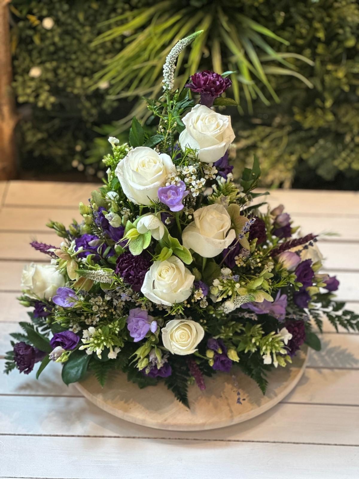 Purple and white flower arrangement by Carol Evelyn Florist